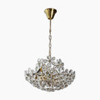 Brass and crystal chandelier with LED flower accents, featuring ornate retro-modern styling.