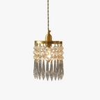 Copper-finished round chandelier with two crystal bead rows, long prisms, E14 compatible.