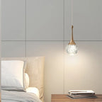 Maison Ornate Luxury Crystal Pendant Light with a round, textured glass shade emitting a soft glow.