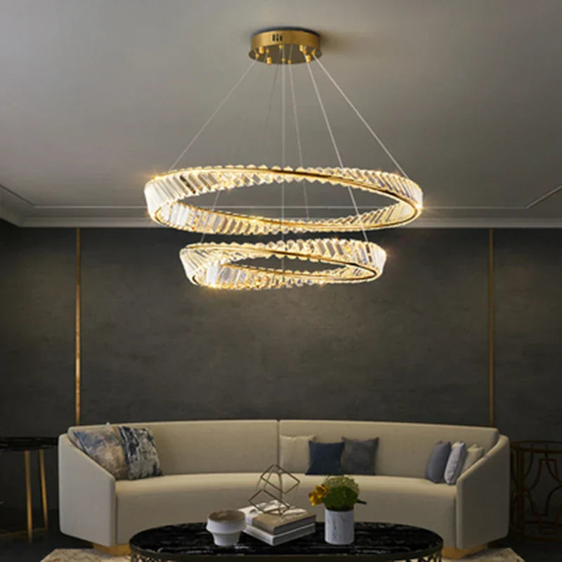 Maison Ornate Gold Crystal LED chandelier with two illuminated overlapping rings, sleek modern lighting.