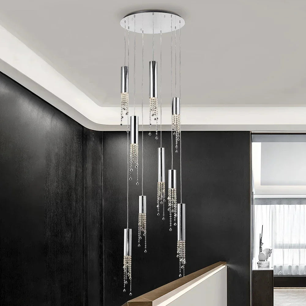 Modern crystal chandelier with silver cylinder pendants, hanging crystals, and energy-efficient LEDs by Maison Ornate.