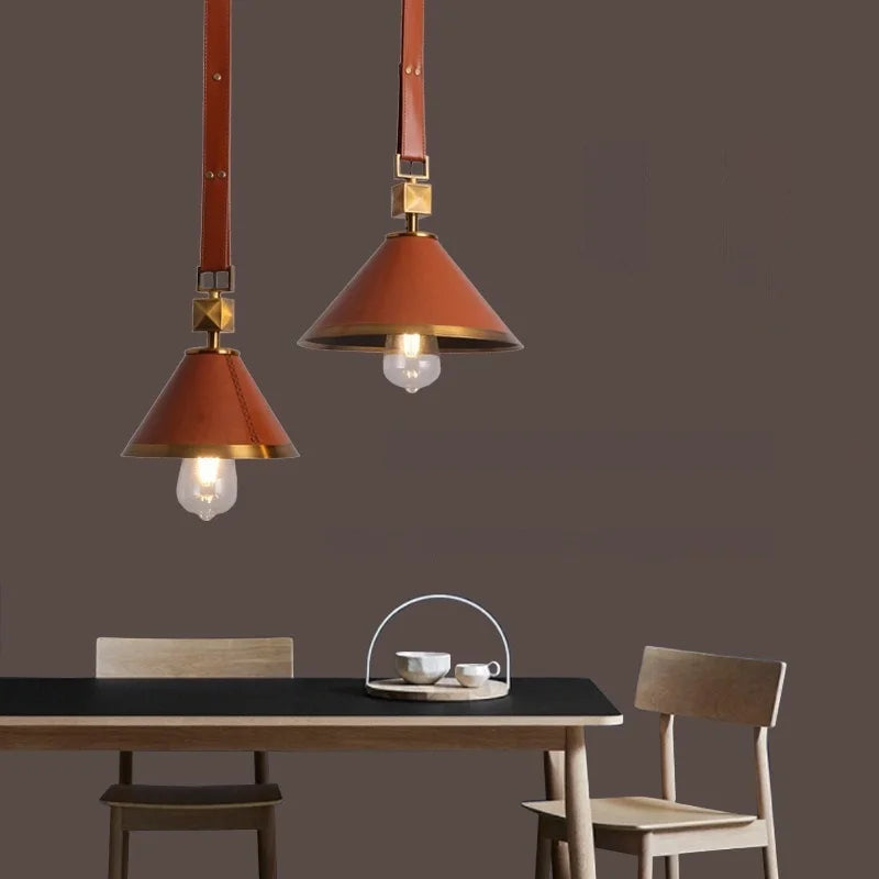 Pair of Maison ornate crystal ball chandeliers with modern glass leather suspensions, elegant and luxurious.
