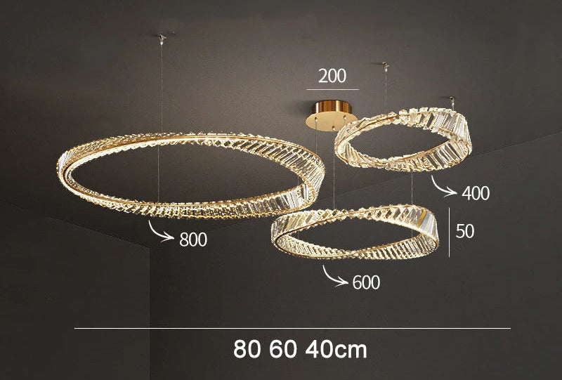 Three overlapping LED crystal rings 80cm, 60cm, 40cm suspended at varied heights.