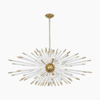 Gold and clear glass rods radiate from a gold sphere, forming an elegant starburst chandelier.