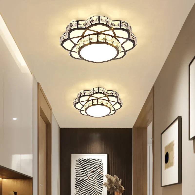 Two Maison Ornate Golden Crystal Floral Decorative LED chandeliers with circular patterns and warm glow.