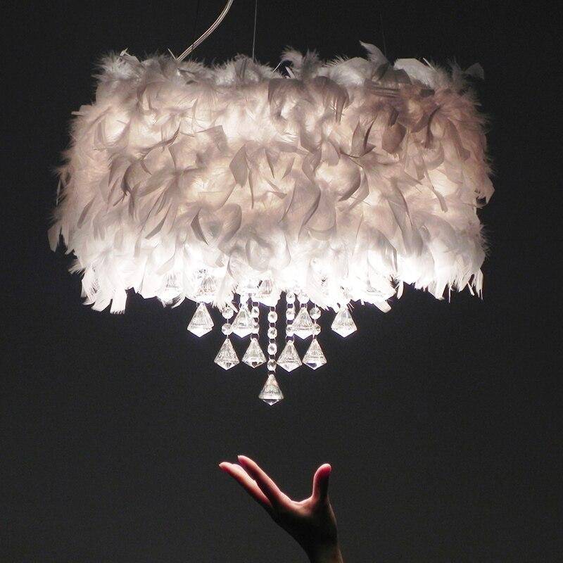 Maison Ornate Round LED Crystal Chandelier with elegant tassels, feathers, white shade, and sparkling crystals.