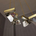 Three Maison Ornate Crystal Spider Chandeliers with gold fittings and geometric shades, sparkling with light.