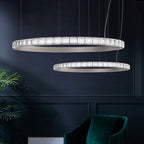 Pair of Maison Ornate modern LED crystal ring chandeliers with diamond accents, suspended from ceiling.