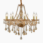 Elegant golden amber K9 crystal chandelier with eight E14 candle lights and ornate gold metal.