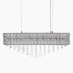 Elegant chrome-finished chandelier with intricate metalwork and clear hanging crystals, suspended by two wires.