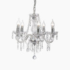 Ornate chrome crystal chandelier with five candle-style bulbs, crystal arms, and dangling prisms.