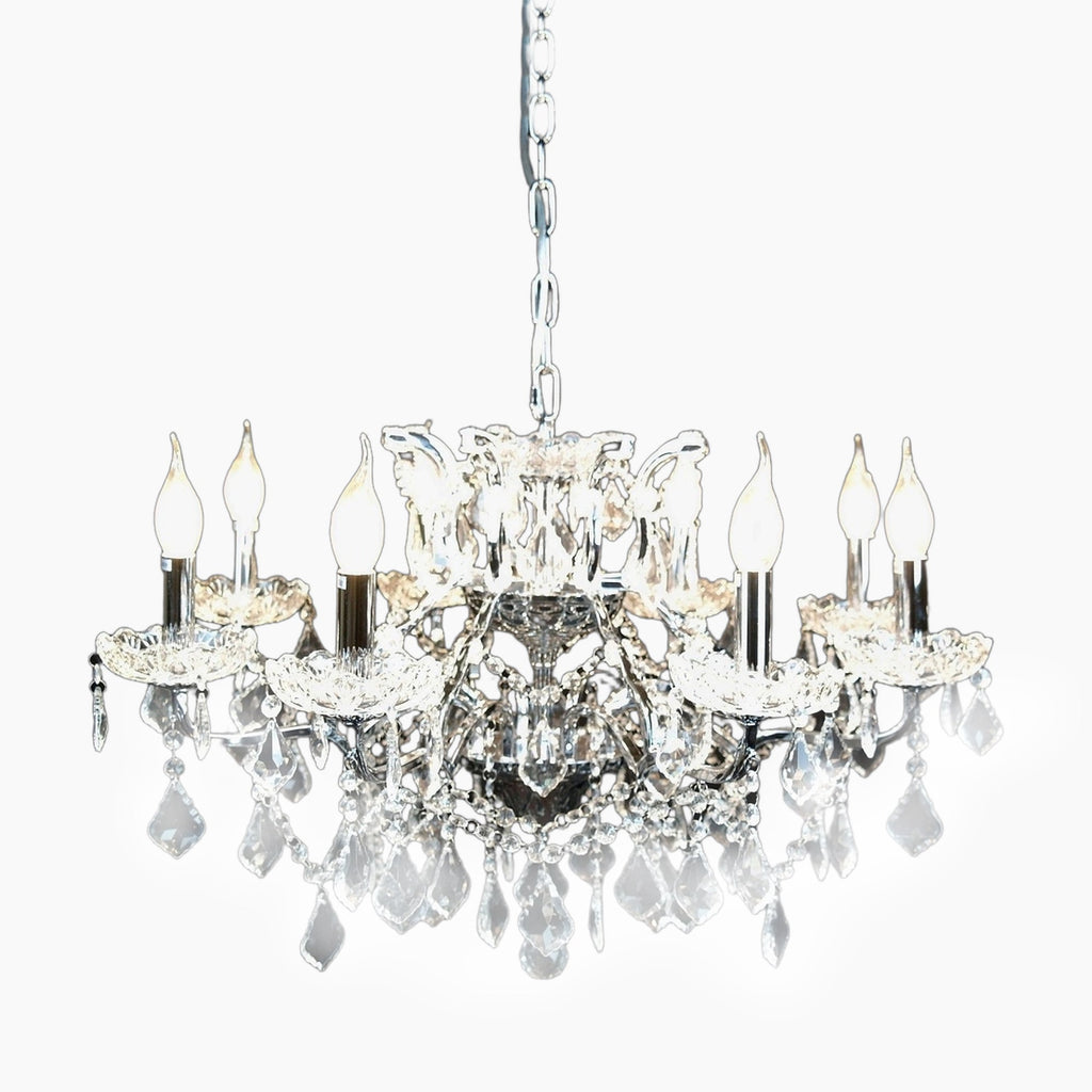 Maison Ornate French chandelier with 8 chrome arms, candle bulbs, clear prisms, silver chain.