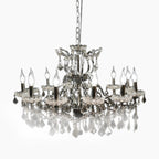 Elegant 12-arm chrome chandelier with sparkling crystal accents, suspended by chain for dramatic display.