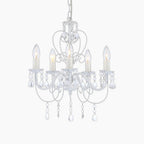 Classic white metal chandelier with five candle bulbs, curved arms, clear pendants, and chain suspension.