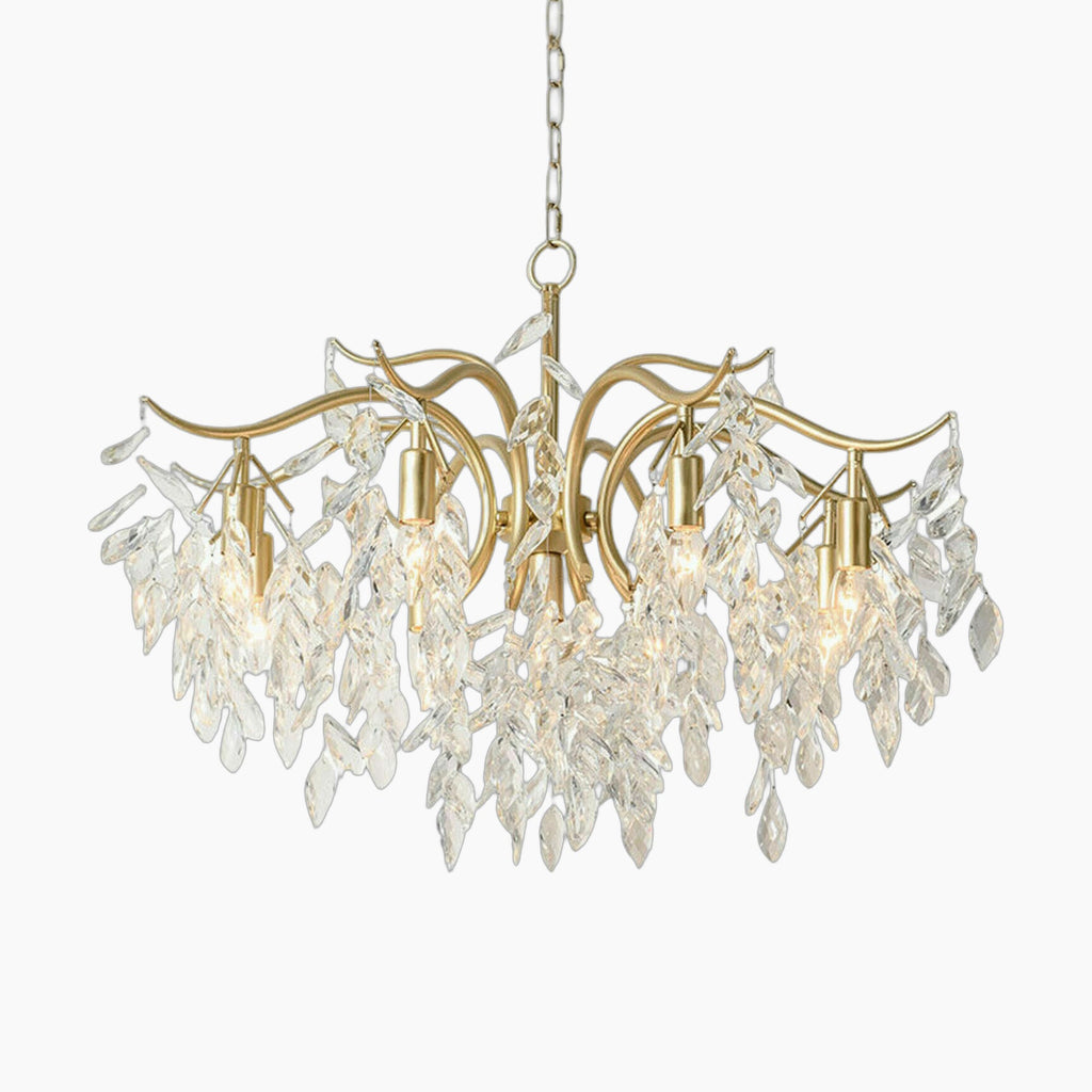Maison Ornate 8-arm gold chandelier with curved arms, crystal leaves, and visible E12 bulbs.