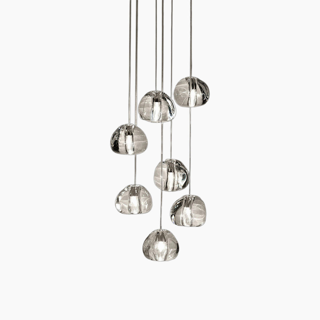Eight clear, irregularly-shaped glass orbs hang at varying heights on thin cords from chandelier.