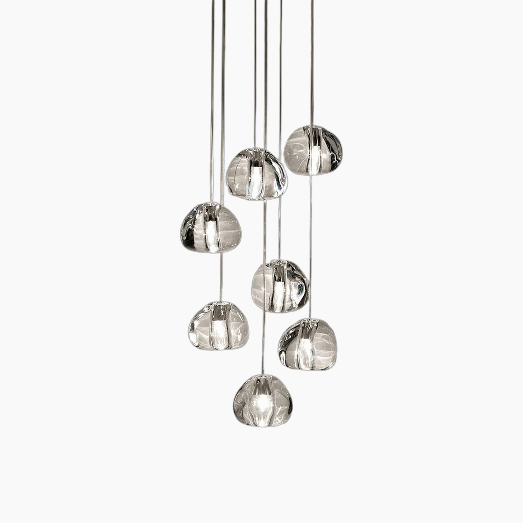 Modern LED crystal chandelier with eight rounded glass pendants suspended at varied heights on slim cords.