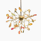 Modern crystal LED chandelier with gold branches and colorful glass petals, Art Deco-inspired design.