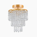 Gold Art Deco chandelier with three tiers of clear crystal prisms, elegant and luxurious design.