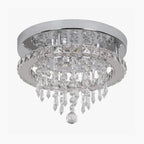 Round chrome base chandelier with tiered crystal pendants, creating a sparkling modern LED fixture.