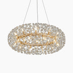 Modern circular crystal chandelier with gold metal, intricate detailing, and multiple bulbs on thin wires.