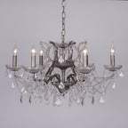 Ornate French style chandelier with six silver glass arms, candle bulbs, and crystal pendants.