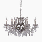 Elegant French crystal chandelier with six silver glass arms, candle bulbs, and faceted crystal drops.