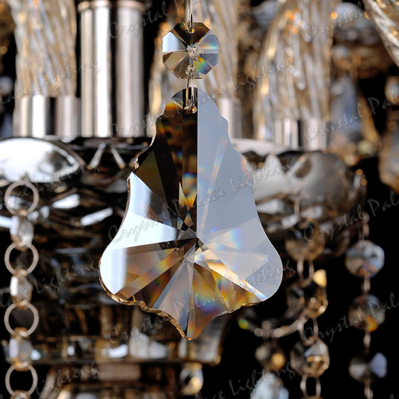 Faceted K9 crystal pendant on Maison Ornate Champagne Chandelier, reflecting rainbows, metallic details gleaming.