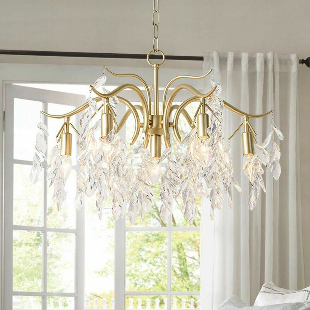 The Maison Ornate Crystal Chandelier features eight gold arms with sparkling crystals for modern elegance.
