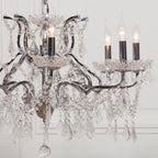 Maison Ornate French Style Crystal Chandelier with chrome arms, ornate metalwork, prisms, and candle bulbs.