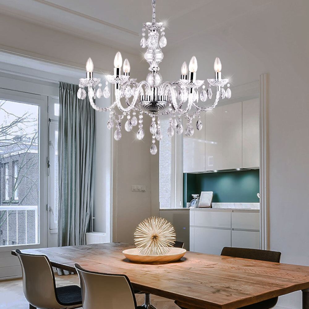 Maison Ornate Elegant Crystal Chandelier with silver tassels and chrome structure, gracefully suspended overhead.