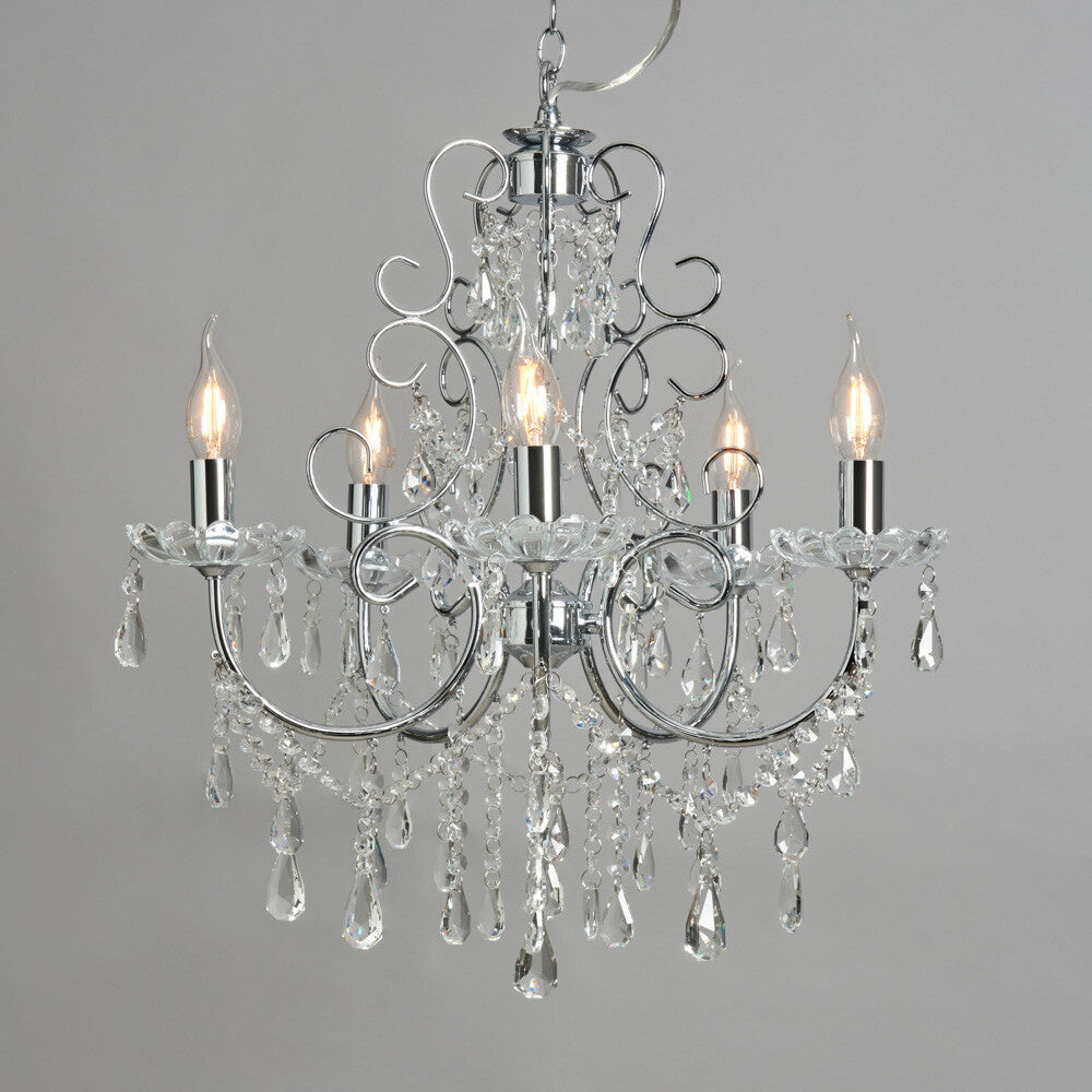 Five-arm polished chrome chandelier with sparkling crystal accents and candle-style bulbs for elegance.