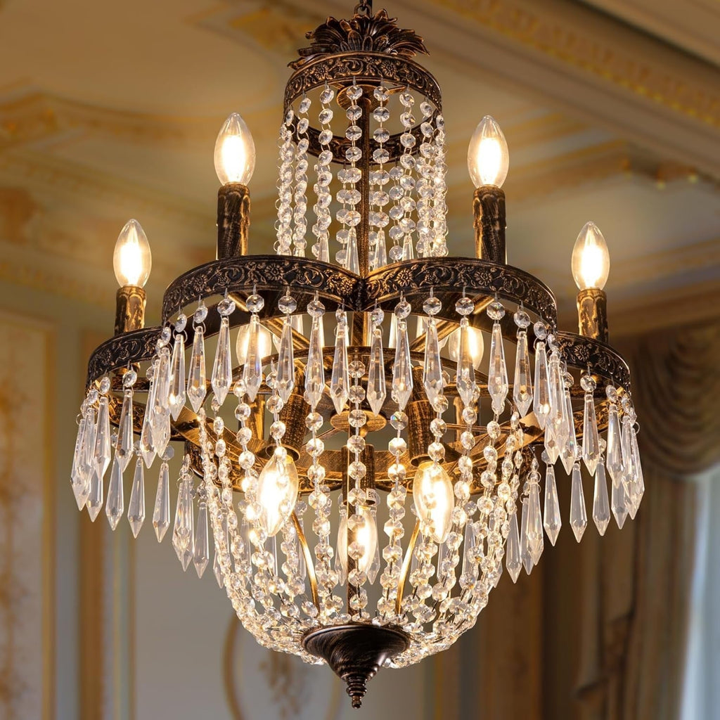 Gold-accented French Empire chandelier with 9 candle lights, ornate crystal strands and pendants.