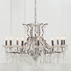 Ornate French chrome chandelier with 12 arms, candle bulbs, and hanging crystal prisms.