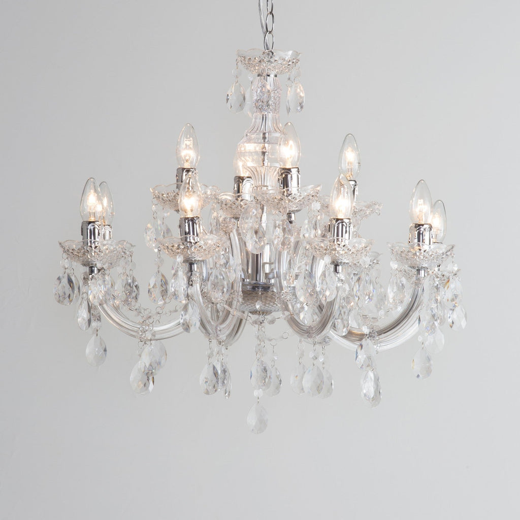 Maison Ornate Art Deco chandelier with chrome arms, eight candle bulbs, and acrylic pendants.