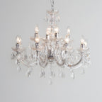 Maison Ornate Art Deco chandelier with chrome arms, eight candle bulbs, and acrylic pendants.