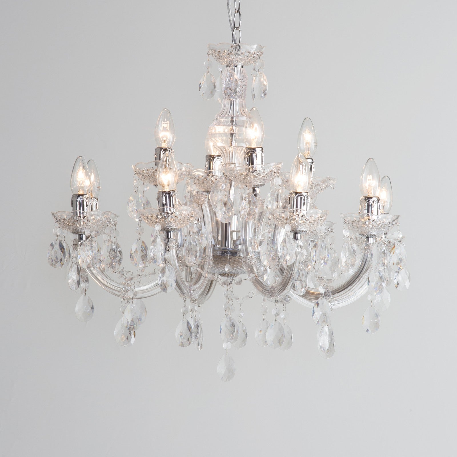 Maison Ornate Art Deco chandelier with chrome arms, eight candle bulbs, and acrylic pendants.