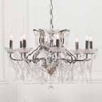 Maison Ornate French chandelier with 8 chrome arms, candle bulbs, and cascading crystal prisms.