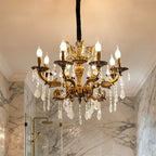 Maison Ornate Antique Crystal Chandelier with 12 brass arms, candle bulbs, and draped crystal ornaments.
