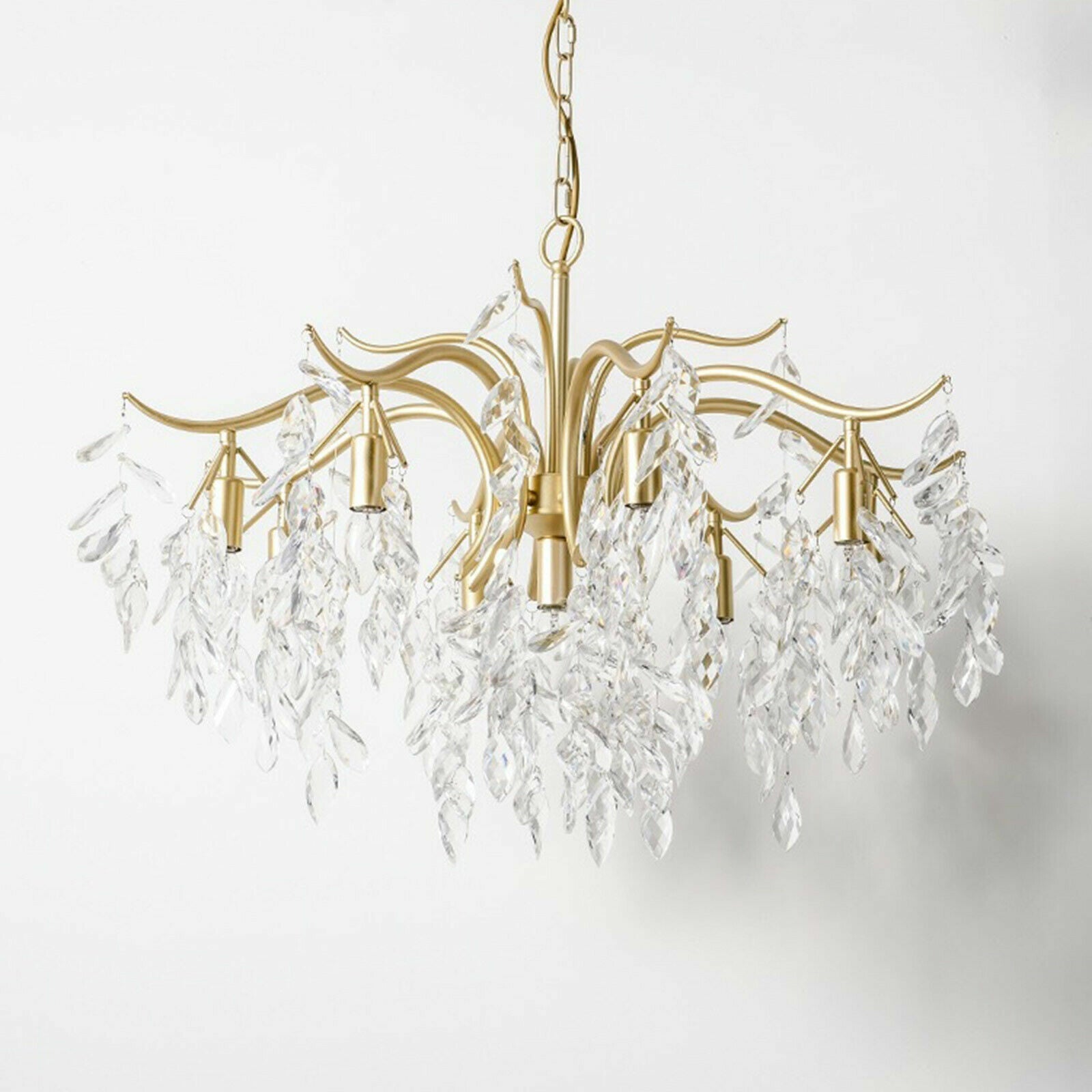 Elegant gold 8-arm chandelier with curved arms and K9 crystal leaves, modern refined design.