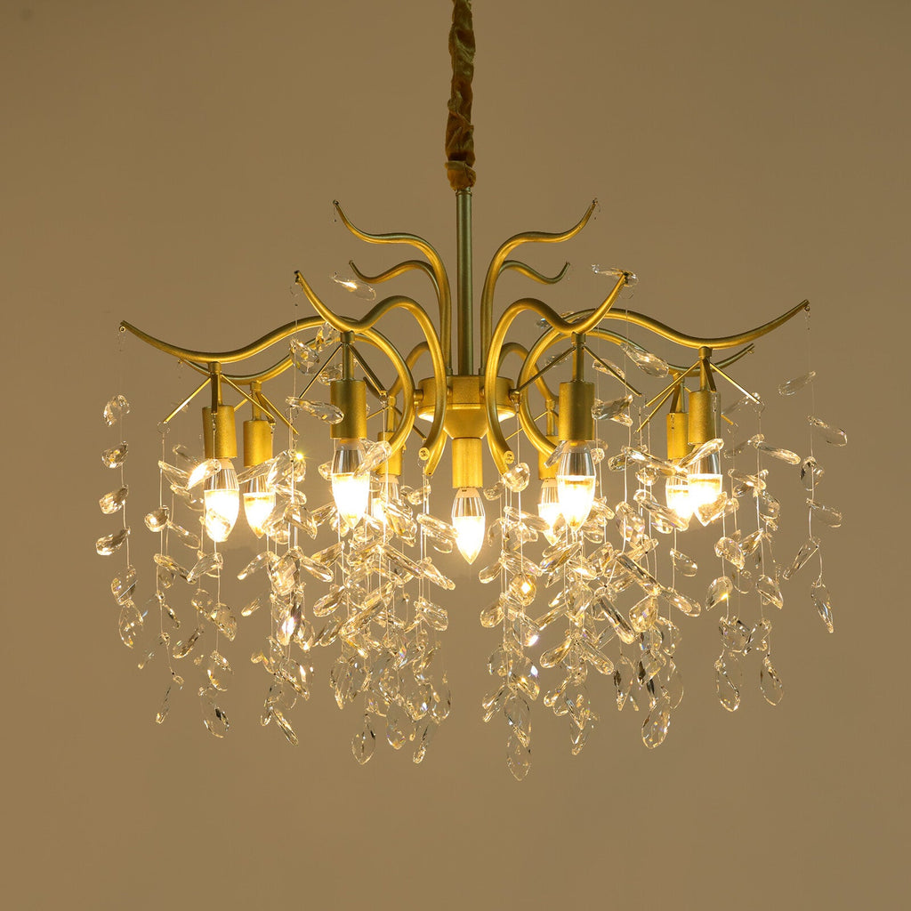 Modern gold branch chandelier with six bulbs, crystal accents, and elegant curved shimmering details.