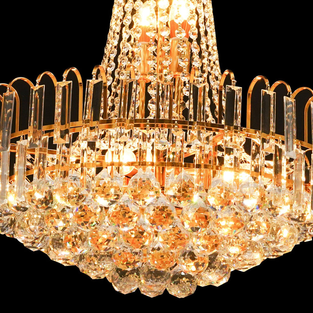 Close-up of Maison Ornate Empire Gold Tassel Crystal Chandelier with glowing prisms and beads.