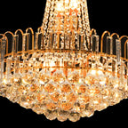 Close-up of Maison Ornate Empire Gold Tassel Crystal Chandelier with glowing prisms and beads.