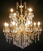 Multi-arm crystal chandelier with candle-style bulbs and gold accents, exuding elegant, warm illumination.