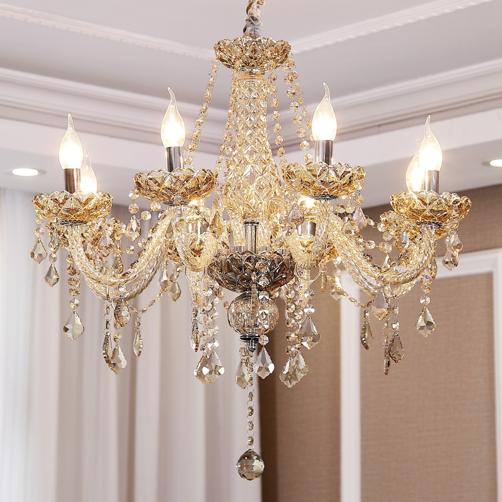 Maison Ornate K9 Crystal Chandelier with golden arms, crystal pendants, and six candle-style bulbs.