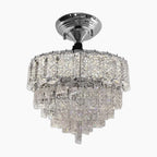 Chrome chandelier with tiered crystal prisms, ceiling-mounted, offering a sparkling, elegant statement.