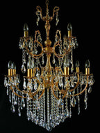 Ornate gold chandelier with geometric arms, candle-style bulbs, and crystal glass prism accents.