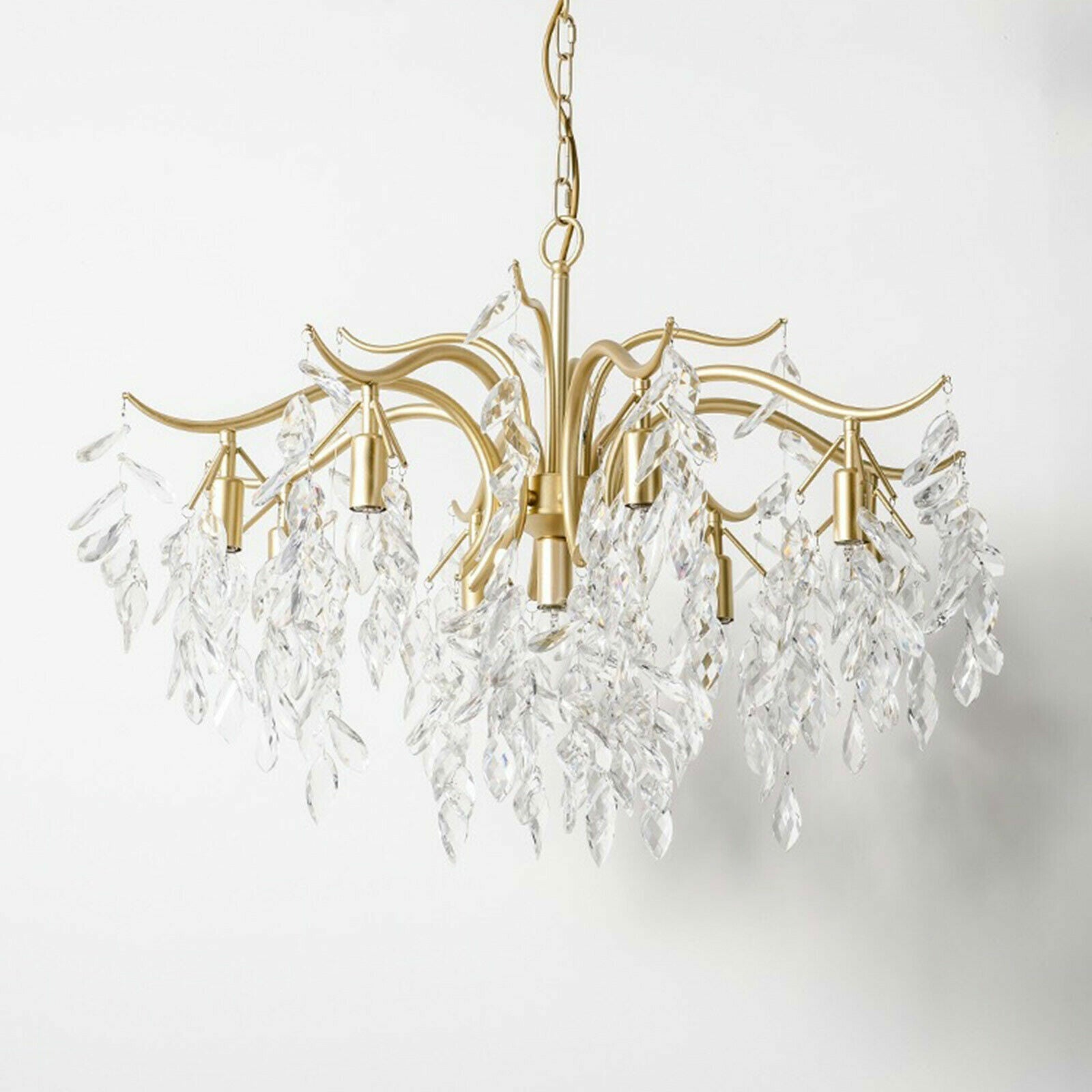 Maison Ornate 8-arm gold crystal chandelier with curved wrought iron arms and hanging clear drops.