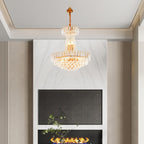 Maison Ornate Empire Style chandelier with gold tassels and crystals, hanging from a white ceiling.
