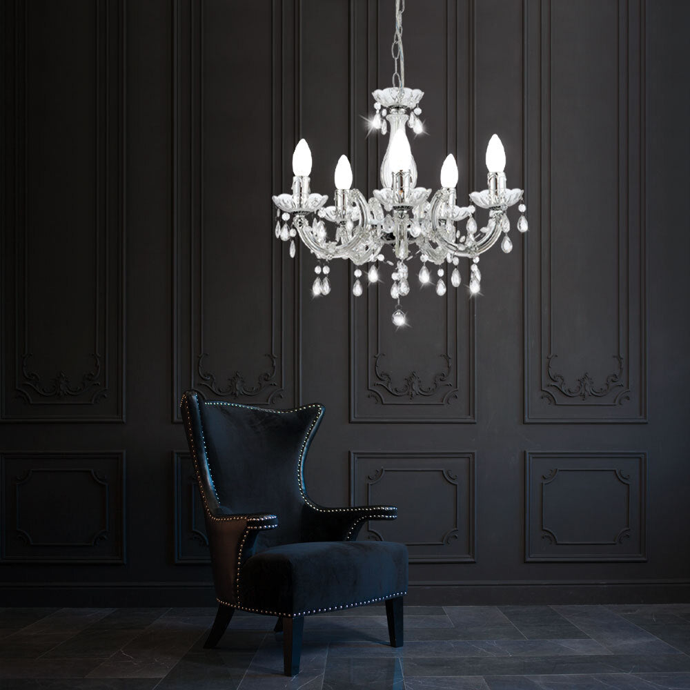 Maison Ornate Elegant Crystal Pendant Light, chrome finish, sparkles with multiple lit bulbs overhead.
